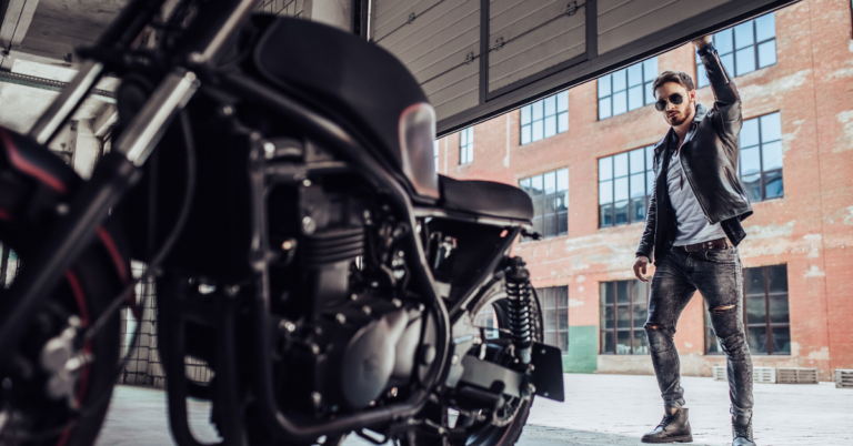 Man in garage looking at motorcycle