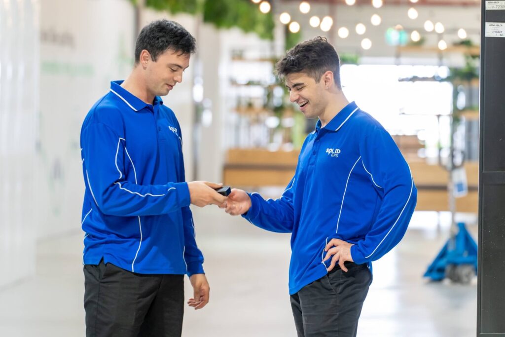The Solid GPS founders holding the GPS tracker